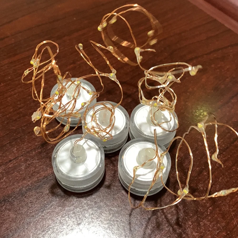 Set of five floral votive table decorations with lights